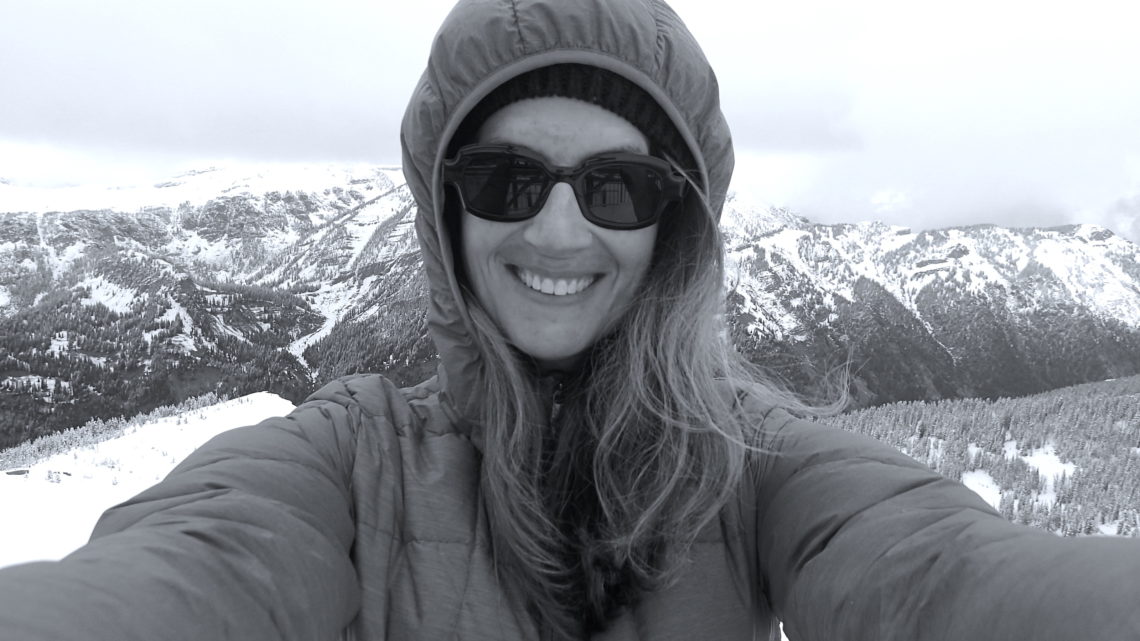 Selfie of Maria in a ski jacket with the Tetons behind her